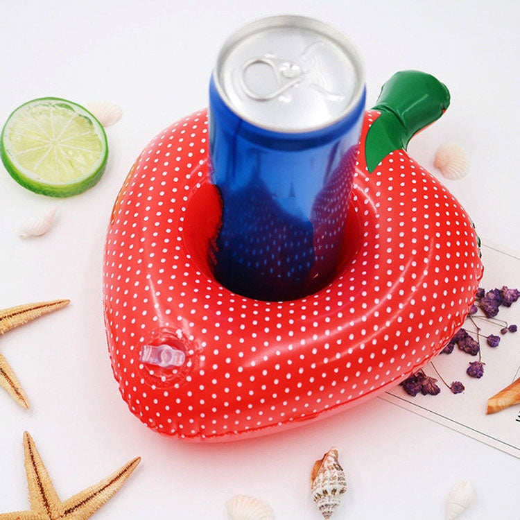 Red polka-dot inflatable strawberry cup coaster holding a blue can