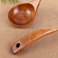 Wooden long-handled spoon with wide bowl and hole at the handle end