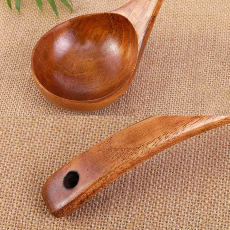 Wooden long-handled spoon with wide bowl and hole at the handle end