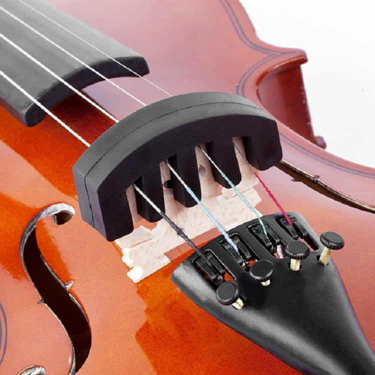 Black silicone violin mute installed on the bridge and strings