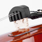 Black silicone violin mute on violin bridge, side view