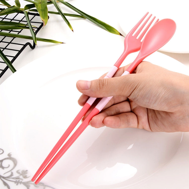 Pink folding fork and spoon utensils held in hand, portable 3-piece dinner set.