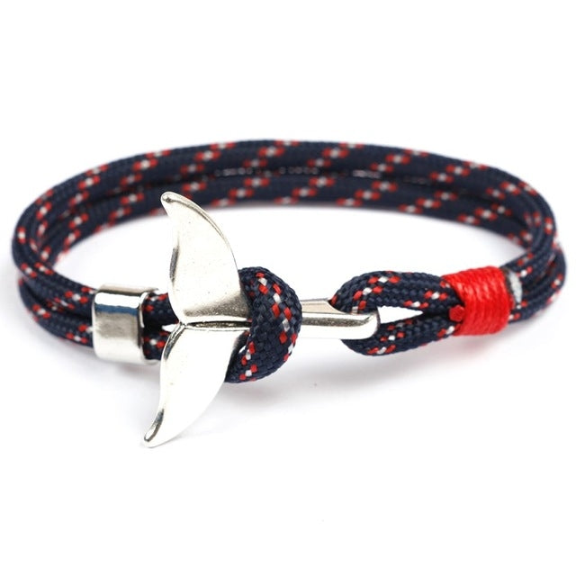 Navy, red, and white rope bracelet with silver whale-tail anchor charm and knot detail
