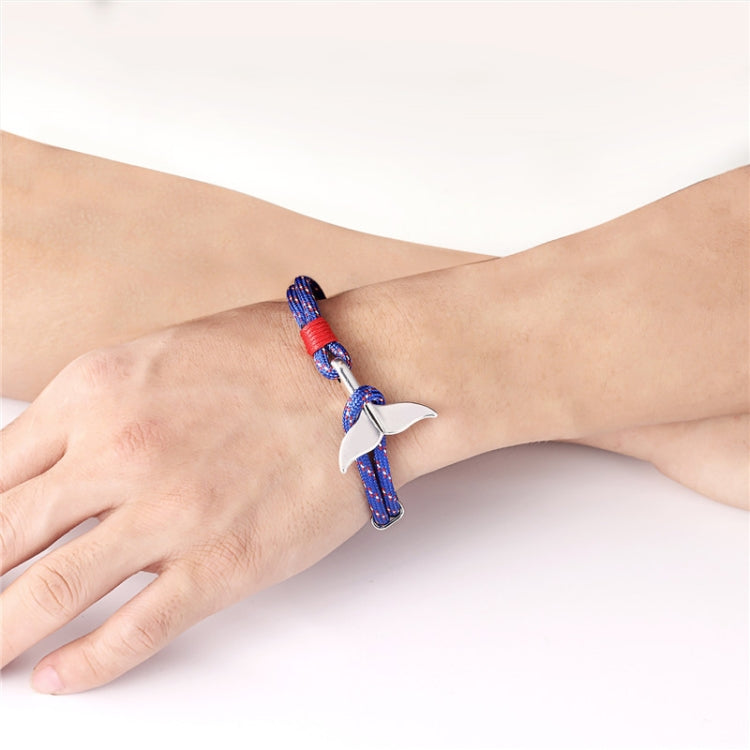 Rope bracelet with blue-and-red strands and silver whale-tail anchor charm on wrist