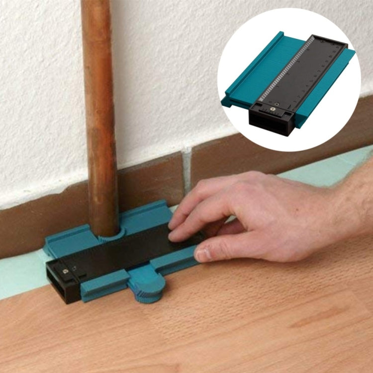 Profile marking tool in use on wood beside pipe, turquoise base with black scale