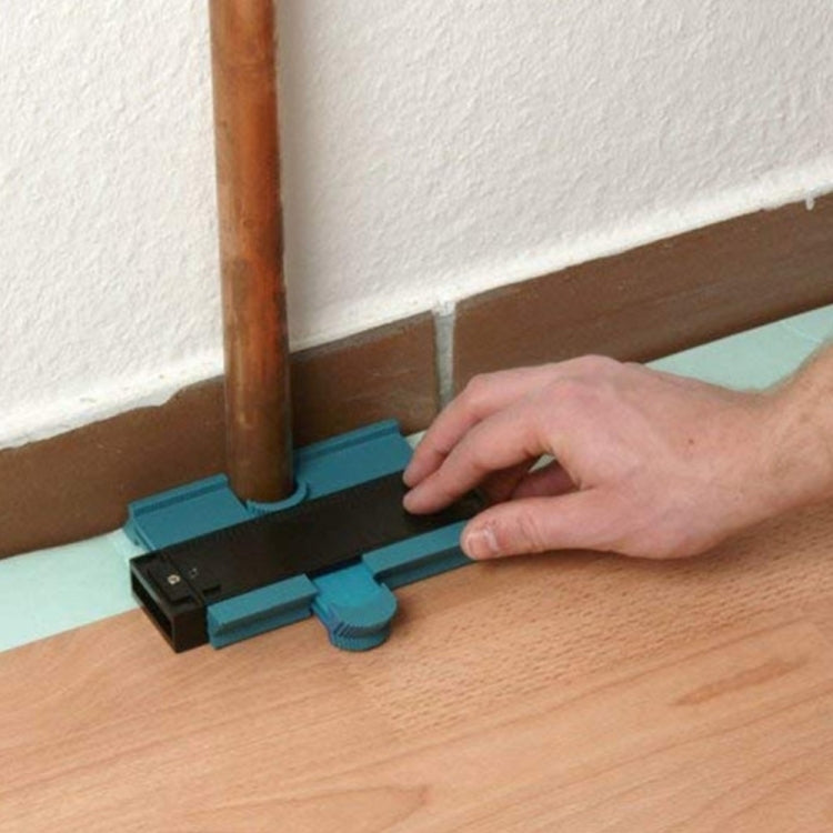 Profile marking tool aligned beside pipe on floor, turquoise frame with black gauge