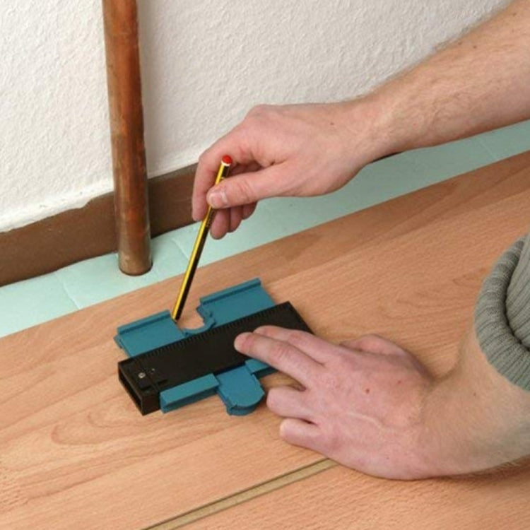 Hands using profile marking tool to mark a conduit on wood, turquoise base and black rail