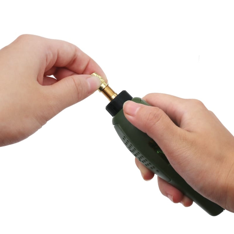 Hands holding a green electric mini drill tool with metal bit installed