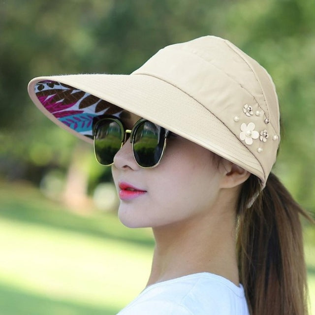 Foldable sun block hat, beige with floral embellishments and wide brim