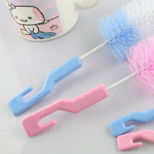 Baby bottle cleaning brush handles in pink and blue with white bristle heads