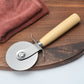 Stainless pizza cutter with wooden handle, round wheel, and fork guard