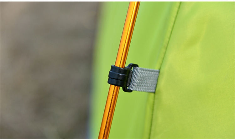 Yellow tent support pole with black strap and grey fabric sleeve on tent