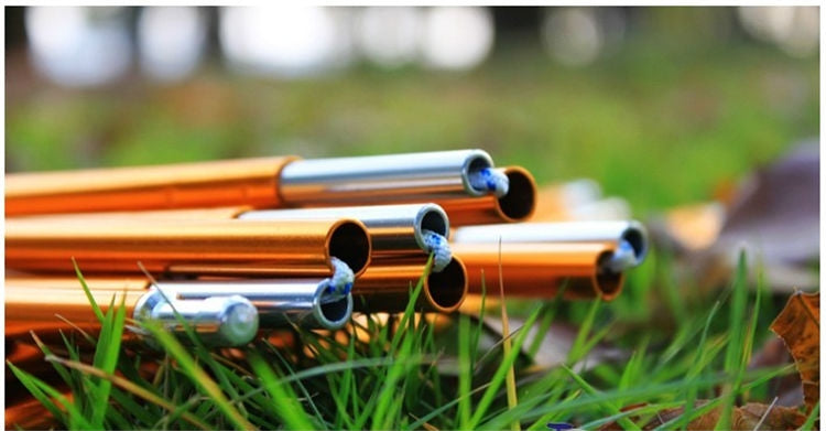 Orange aluminum tent poles with blue connector joints on outdoor grass