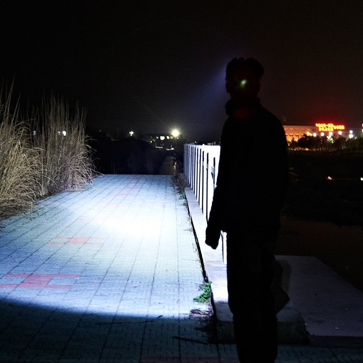 USB rechargeable waterproof sensor headlamp beam visible on walkway, black strap and LEDs
