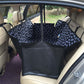 Black pet car seat cover hammock with white paw pattern and padded seat area