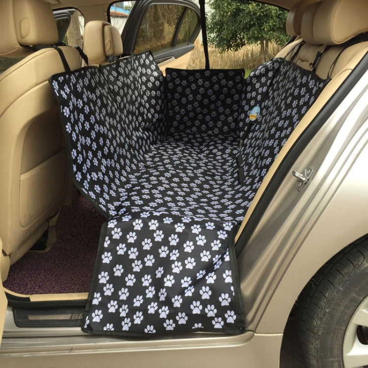 Black pet seat cover hammock with white paw print, folded for rear seat fit