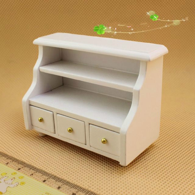 White mini bathroom cabinet with open shelves and three front drawers, gold knobs