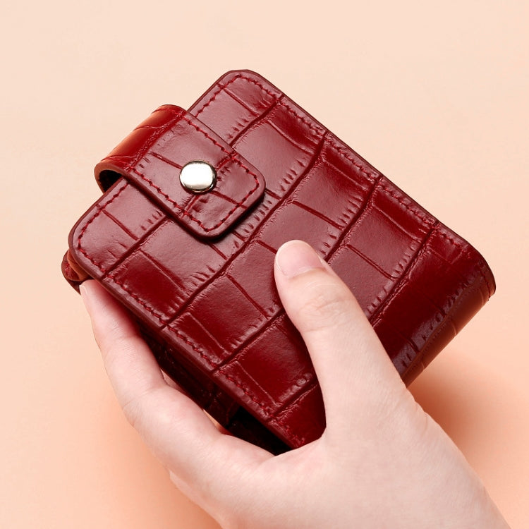Red croc-pattern lipstick storage bag with buttoned flap and top handle loop