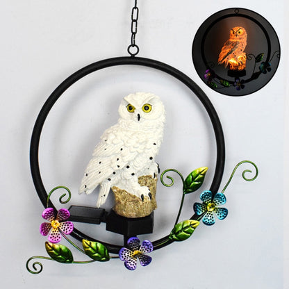 Hanging solar owl garden LED light with white owl figure, black base, decorative flowers