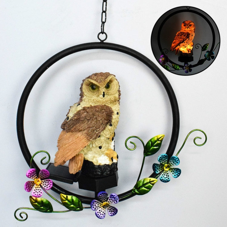 Hanging solar owl garden LED light with brown owl figure, black base, decorative flowers