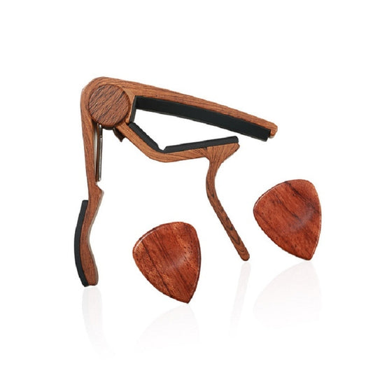 Wood guitar capo with black clamp and three wooden pick plectrums