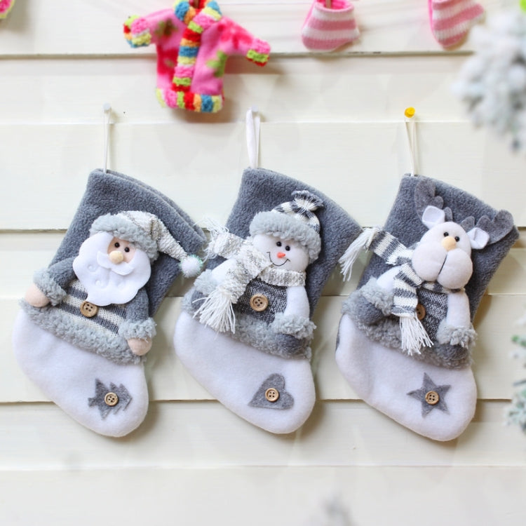 Three plush Christmas stocking gift bags with Santa, snowman, and elk designs