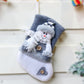 Gray flannel Christmas stocking with snowman holding scarf, button accents, hanging loop