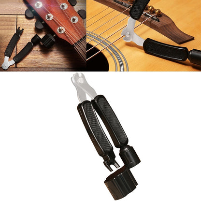 Guitar string changing tool set with clamp, winder handle, and cutter tools on guitar headstock