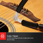 Guitar string changing tool set on acoustic guitar with black grips and metal clamp