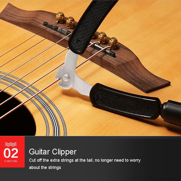 Guitar string changing tool set on acoustic guitar with black grips and metal clamp