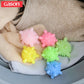 Set of 5 starfish-textured laundry cleaning balls on folded clothes, pink green yellow blue