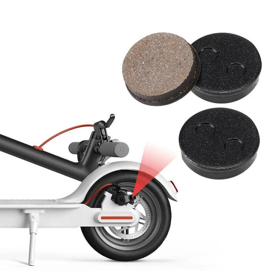 Round disc brake pads, one brown friction face and one black backing, set of 2