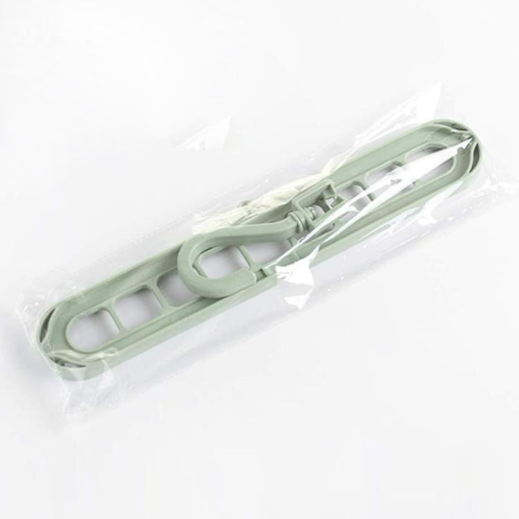 Light green plastic hanger rack in sealed bag with 9-bar design and top hook