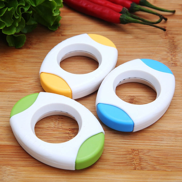 Three white egg openers with yellow and blue and green grip details