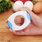 Hand holding white egg opener; circular serrated blade opening visible