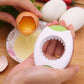 Egg opener cutting an eggshell; yellow egg inside and serrated blade shown