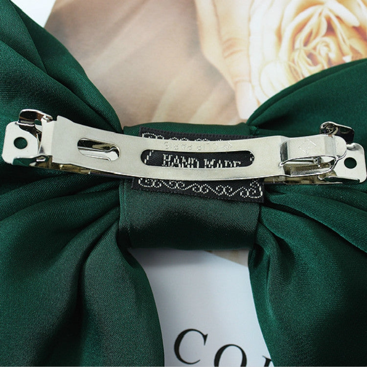 Dark green satin bow hairpin with silver metal barrette and decorative trim