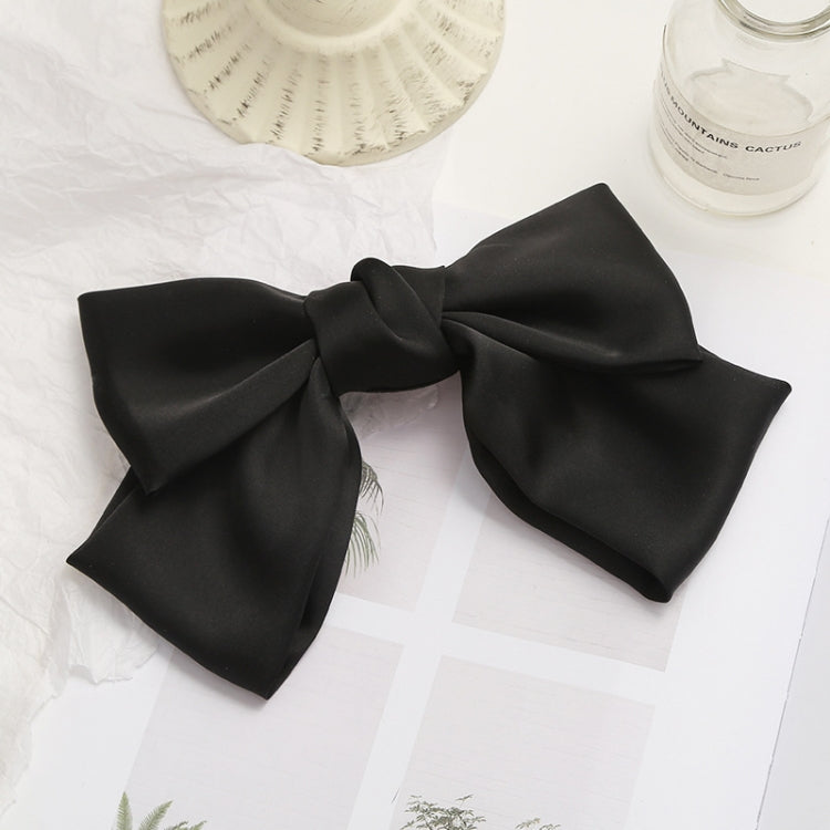 Black satin bow hairpin clip with layered loops and gathered center