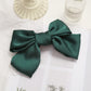 Dark green satin bow hairpin clip with wide loops and centered knot