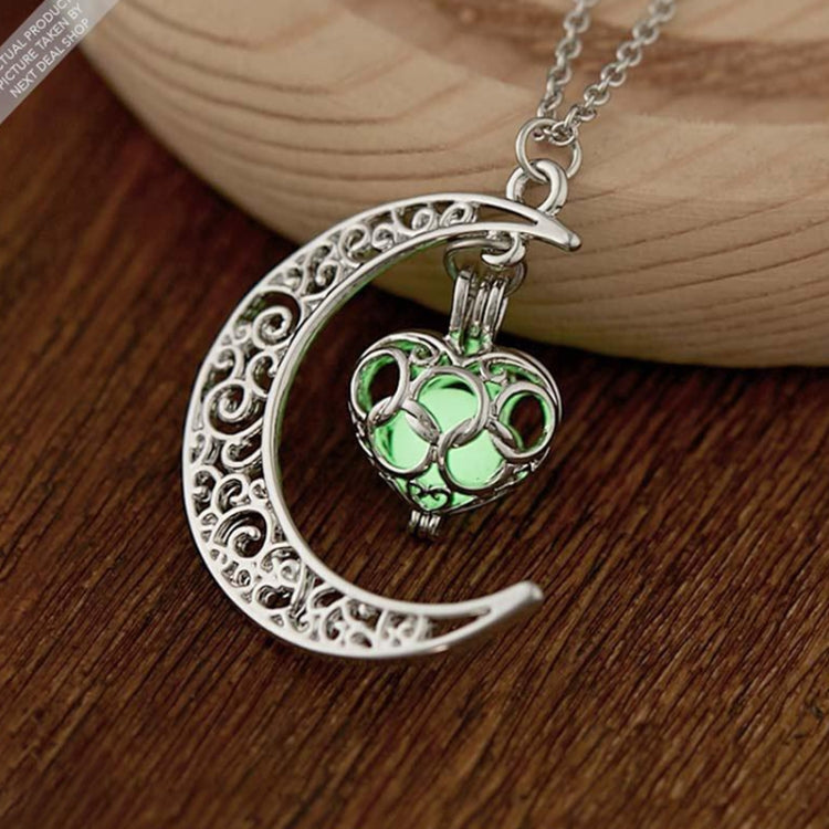 Silver crescent moon charm necklace with filigree design and green luminous gem pendant