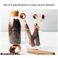 Four-piece copper measuring spoon set with walnut handles, shown in clear container