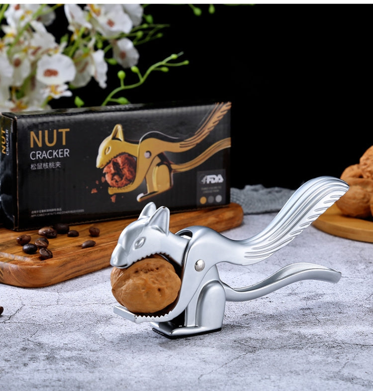Squirrel nut shell clip cracking a walnut with jaws holding shell pieces