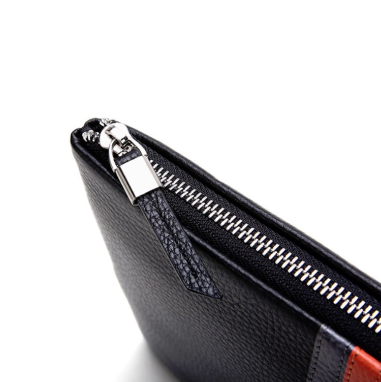 Black leather zip pouch coin purse close-up with metal zipper pull and stitching.
