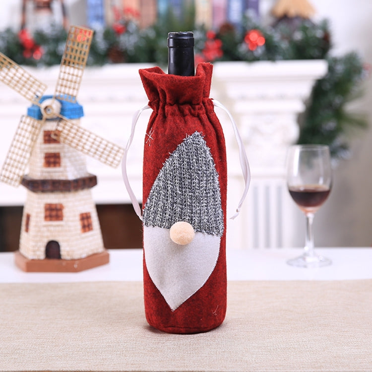 Red felt wine bottle bag with embroidered Santa hat and white beard, drawstring top