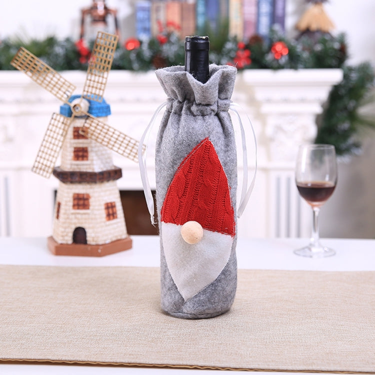 Grey felt wine bottle bag with embroidered Santa hat and white beard, drawstring top