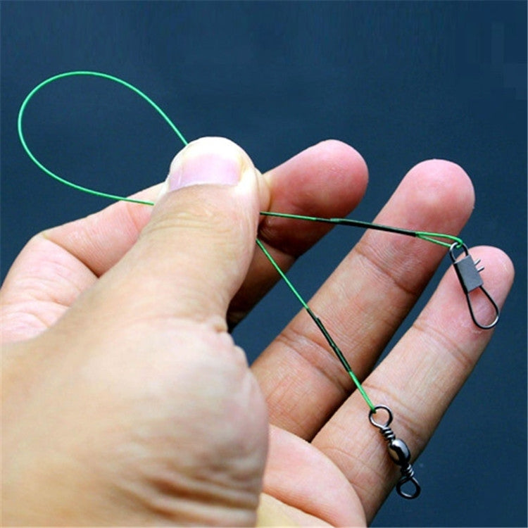 Green fishing wire leader held in hand with metal swivel and snap hook