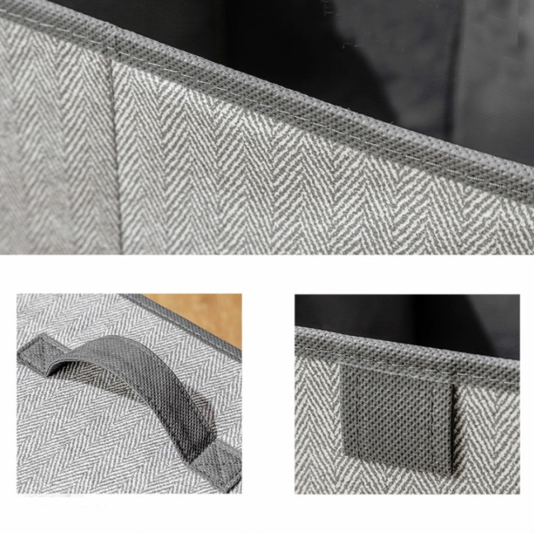 Gray non-woven storage box fabric close-up with reinforced carry handle