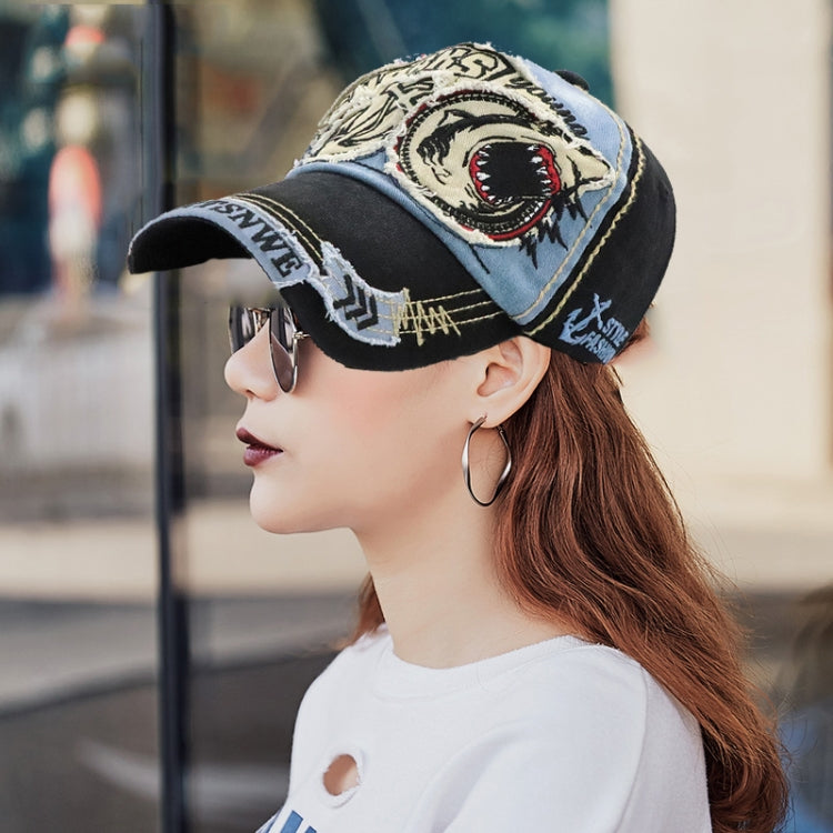 Denim and black baseball cap with embroidered shark patch on front