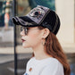 Black baseball cap with embroidered shark patch and distressed side logo stitching