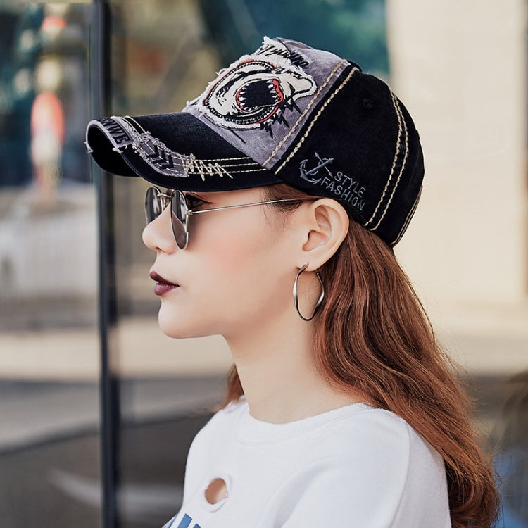 Black baseball cap with embroidered shark patch and distressed side logo stitching
